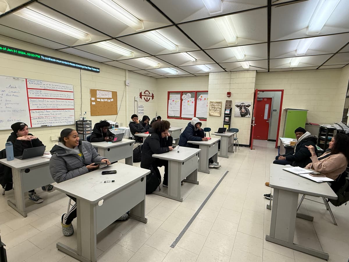 A REBELS cohort in session with students at their desks during a curriculum lecture