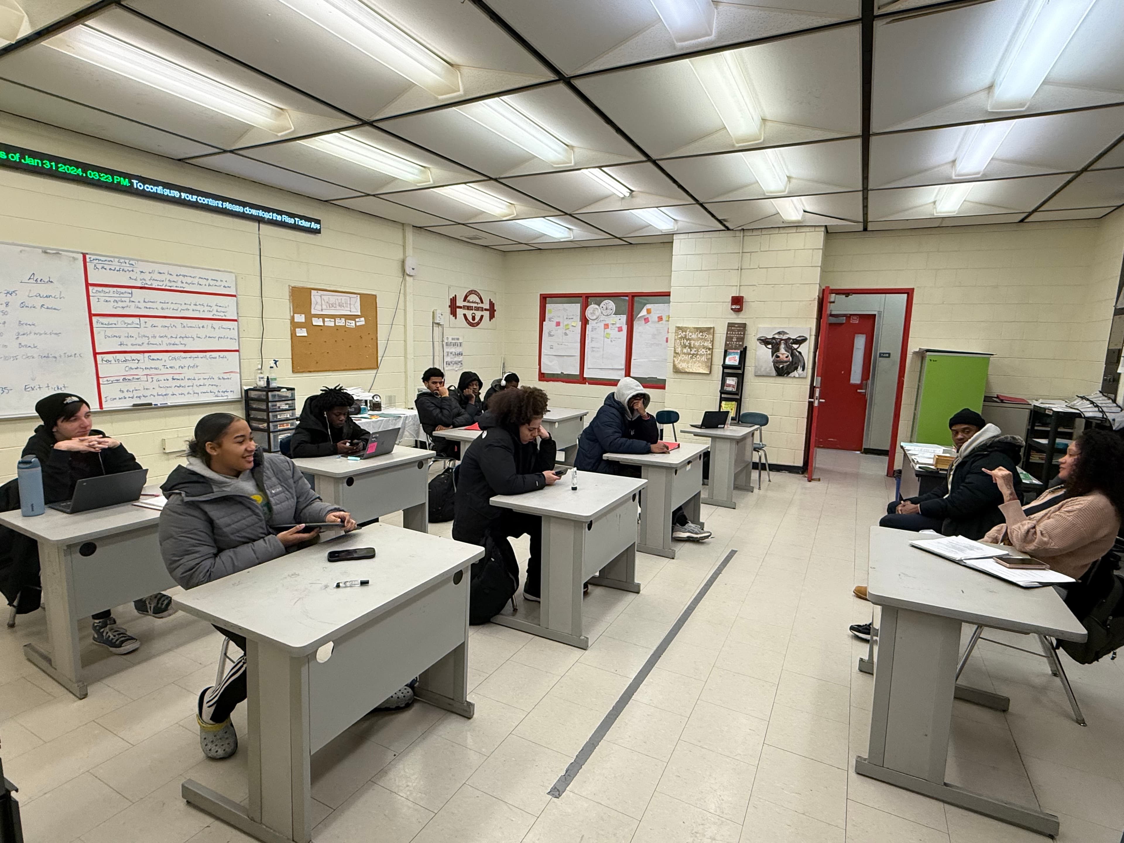 A REBELS cohort in session, students at their desks during a curriculum lecture