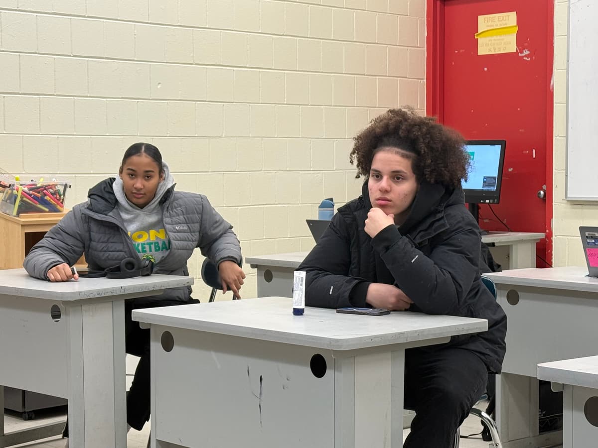 Two REBELS students listening attentively during a cohort session